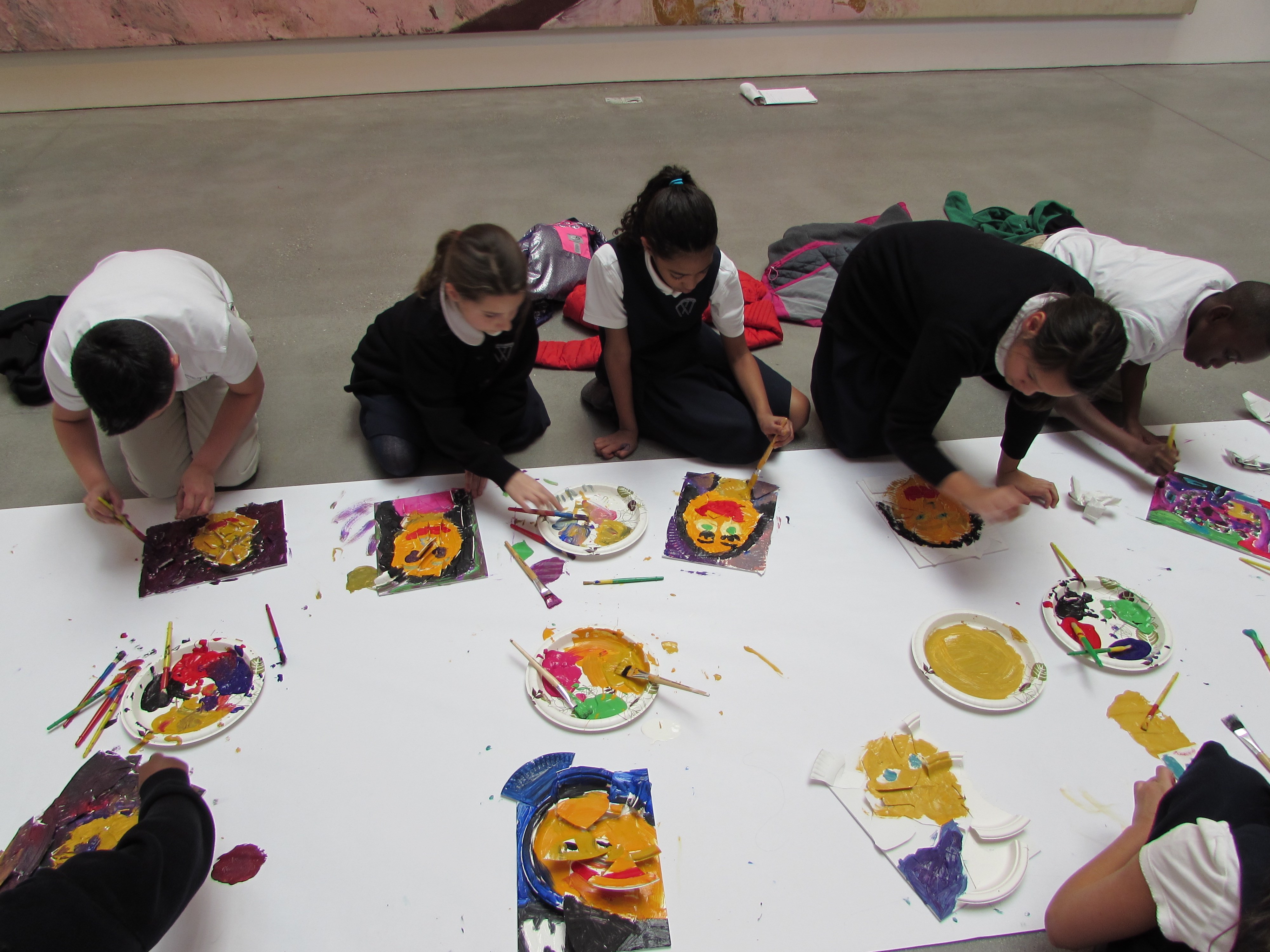 Students working on their own plate portraits, inspired by Julian Schnabel's exhibition at The Brant Foundation
