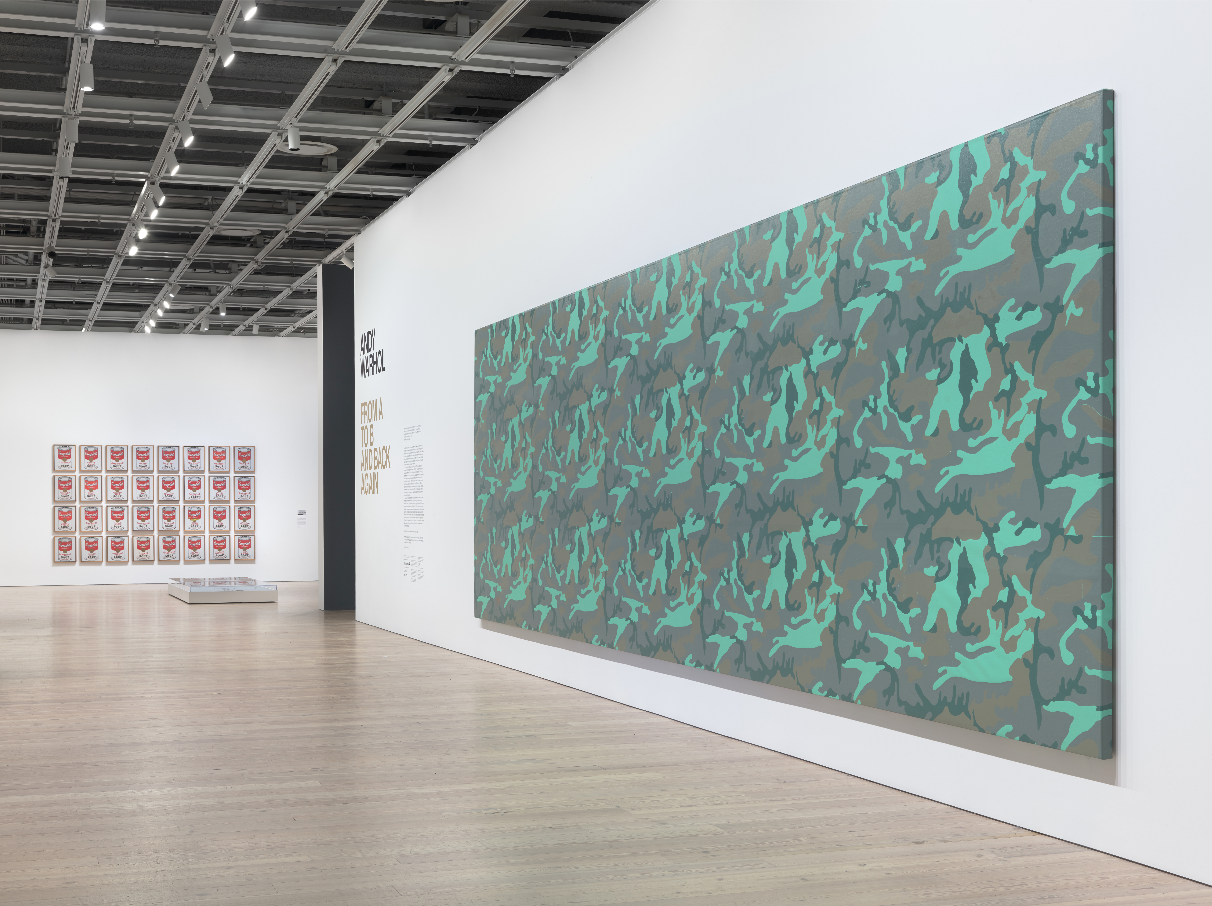 Installation view of Andy Warhol – From A to B and Back Again (Whitney Museum of American Art, New York, November 12, 2018-March 31, 2019). From left to right: Campbell’s Soup Cans, 1962; Camouflage, 1986. Photograph by Ron Amstutz.